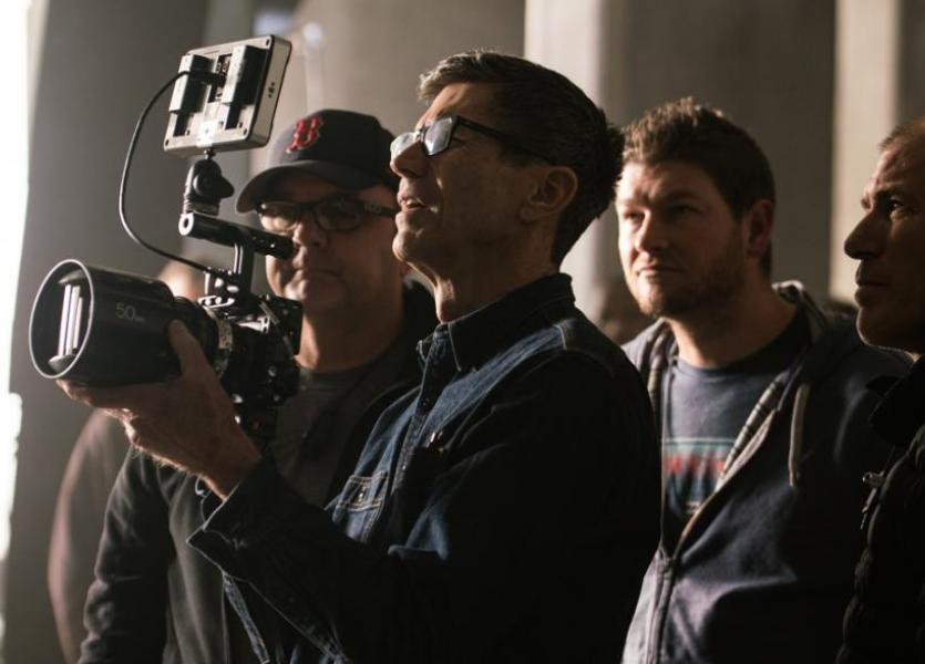 Cinematographer Bill Pope looking at a camera behind the scenes of Baby Driver