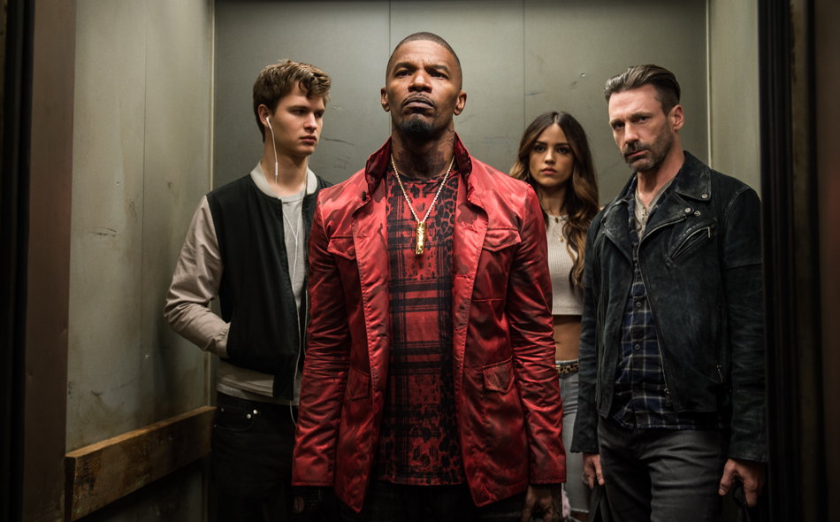 The crew from Baby Driver standing in the elevator together
