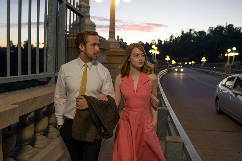 Ryan Gosling and Emma Stone walking along the pavement from the film La La Land